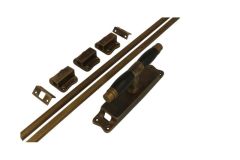 Crémone en applique laiton patiné bois d'ébène (1928)